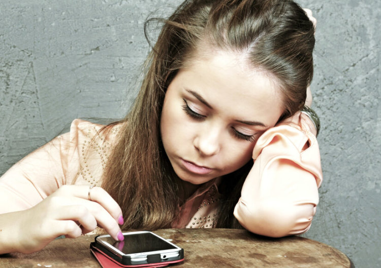 Sad girl with mobile phone