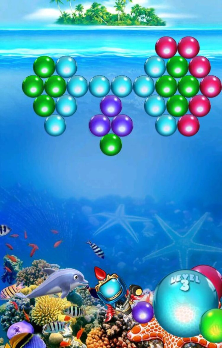 Дельфин убирает с экрана разноцветные шарики. Фото.